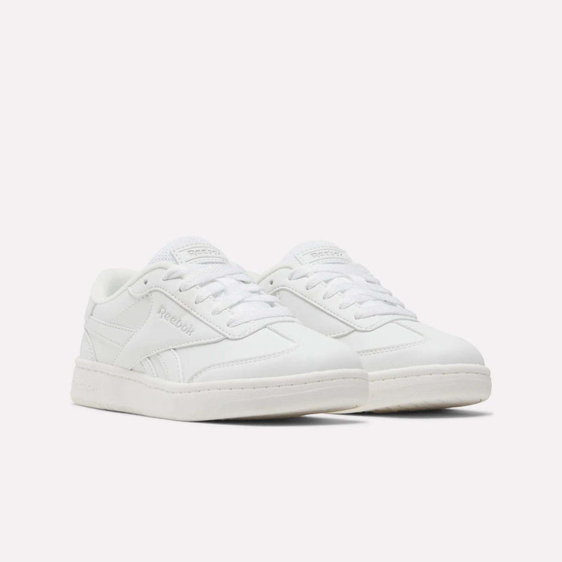 A pair of Reebok Forte Pitch Shoes for little kids, featuring a low-top, tennis-inspired design in white with matching white laces and subtle Reebok branding on the sides and tongue, set against a plain white background.