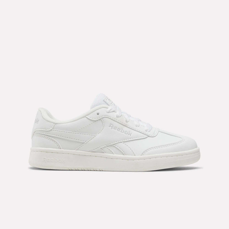 The Reebok Forte Pitch Shoes for little kids are shown in white, featuring a low-top, court-inspired design with white laces and understated stitched details, set against a simple light background.