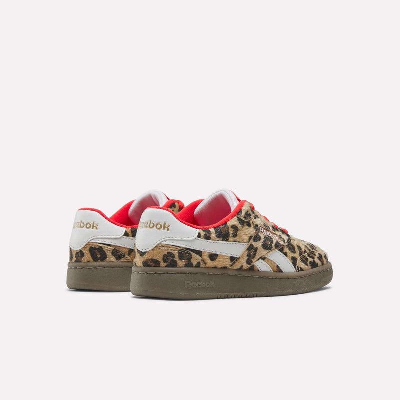 A rear view of two leopard-print Forte Match T Shoes - Big Kids by Reebok, featuring white side stripes, red interior lining, and brown rubber soles.