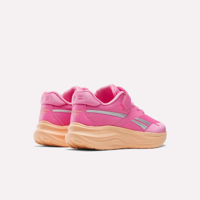 Pair of bright pink Reebok Blitzr Run 1V Running Shoes - Little Kids with thick peach-colored soles.