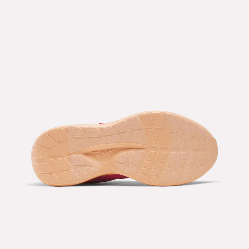 Bottom view of a pink Reebok Blitzr Run 1V Running Shoes - Little Kids with a textured peach-colored sole.