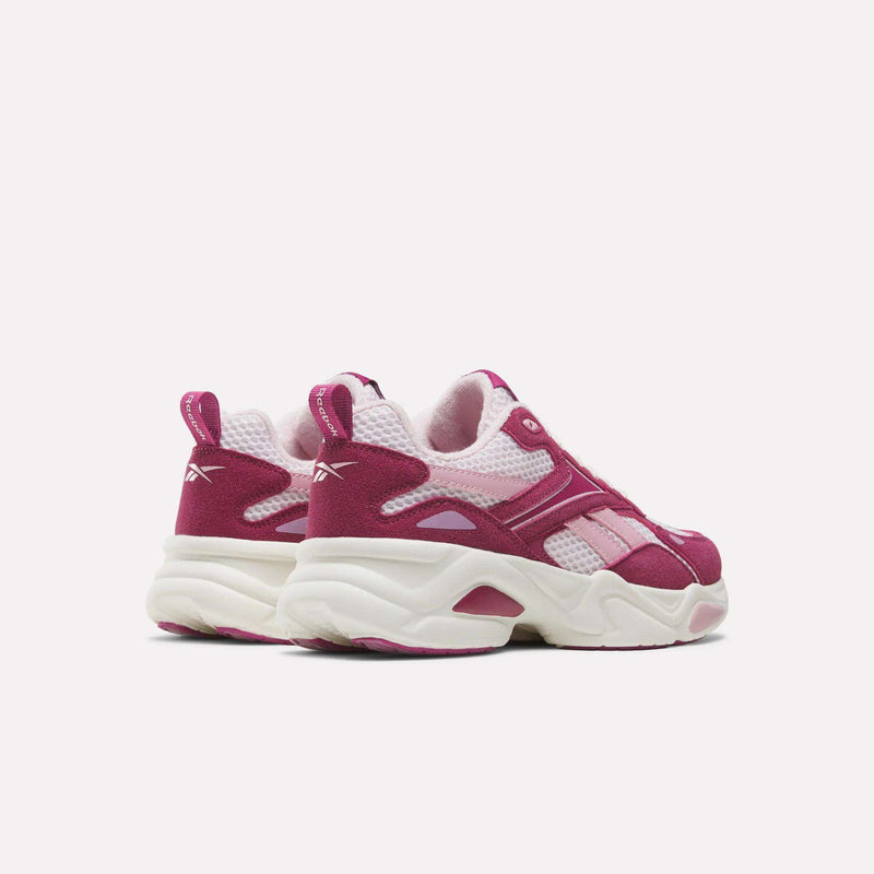 Pair of pink and white Reebok Charge Shoes - Big Kids with thick, chunky, running-inspired soles.