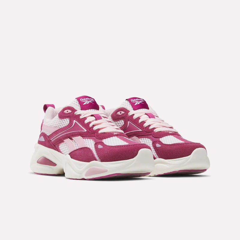 Magenta and white Charge Shoes - Big Kids by Reebok with thick white soles and laces.