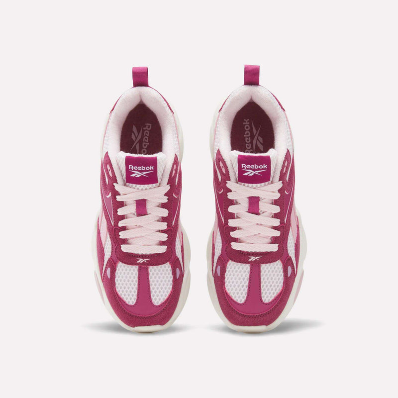 Top-down view of magenta and white Charge Shoes - Big Kids by Reebok, featuring mesh panels and light pink laces.