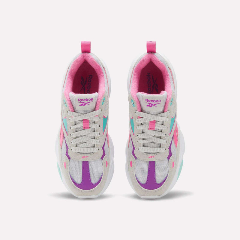 Pair of white, pink, and purple Charge Shoes - Big Kids Reebok running-inspired sneakers with laces and pull tabs.