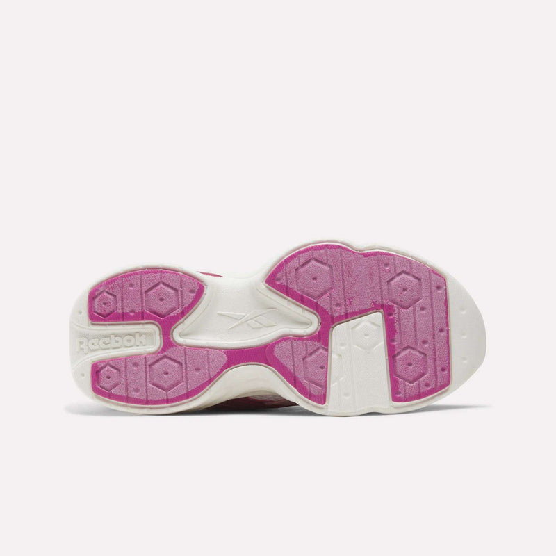 White and pink Reebok Charge Shoes - Little Kids running shoes feature an outsole with a geometric tread pattern.