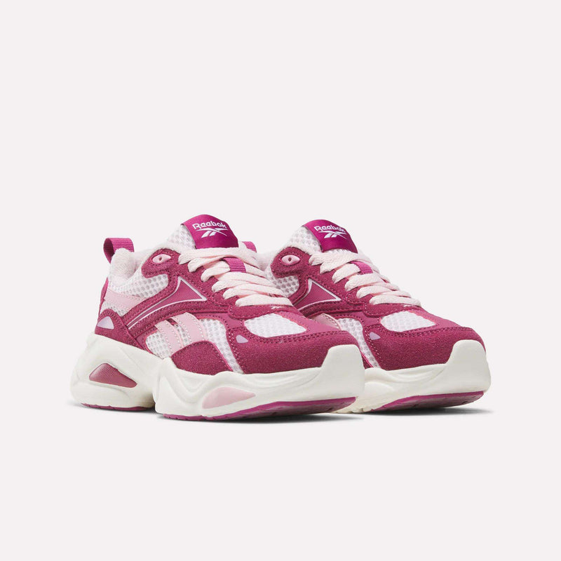 White mesh Reebok Charge Shoes - Little Kids with magenta overlays, pink laces, and thick, cushioned white soles.