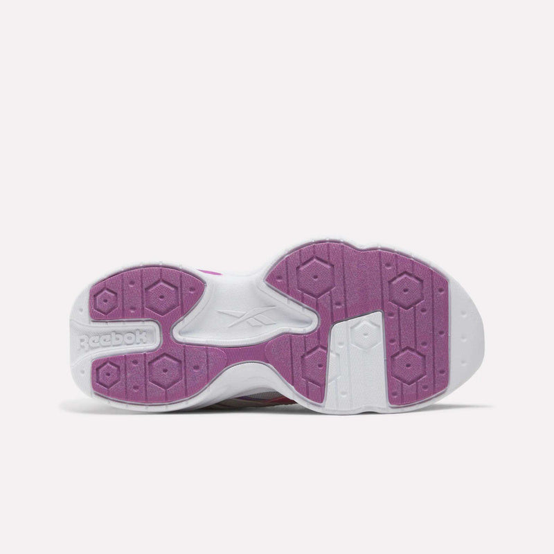 The white and purple treaded sole of a Reebok Charge Shoes - Little Kids sneaker.