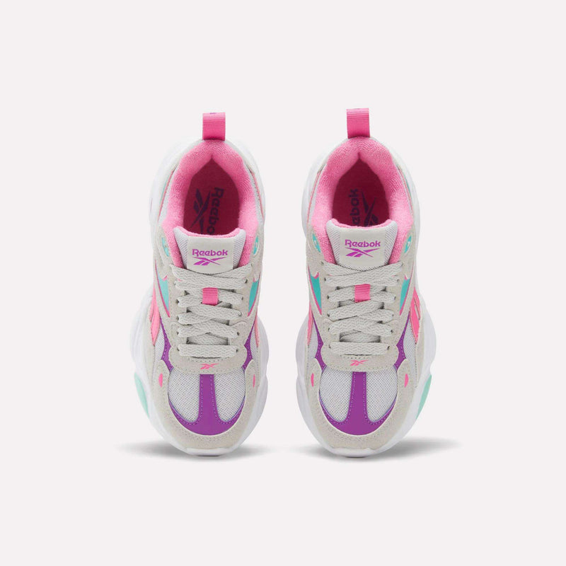 Top-down view of white, grey, purple, and pink Charge Shoes - Little Kids by Reebok.