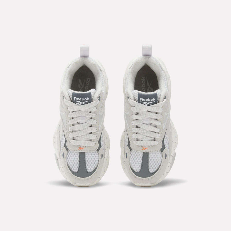 Light gray and white Reebok Charge Shoes - Little Kids with laces and pull tabs at the heels.