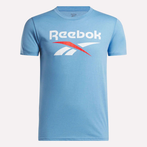The Men's Stacked Vector Graphic T-Shirt by Reebok is light blue, made from 100% cotton, and features the white and red Reebok logo and name across the chest. Shown on a plain white background.