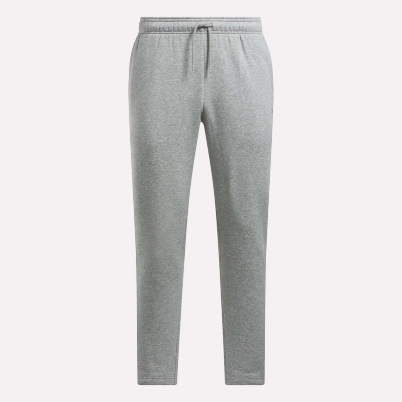 Men’s Patent Pants by Reebok in light grey, featuring an adjustable waistband with drawstring, side pockets, and a relaxed tapered fit. The slim fit pants are shown against a plain white background.