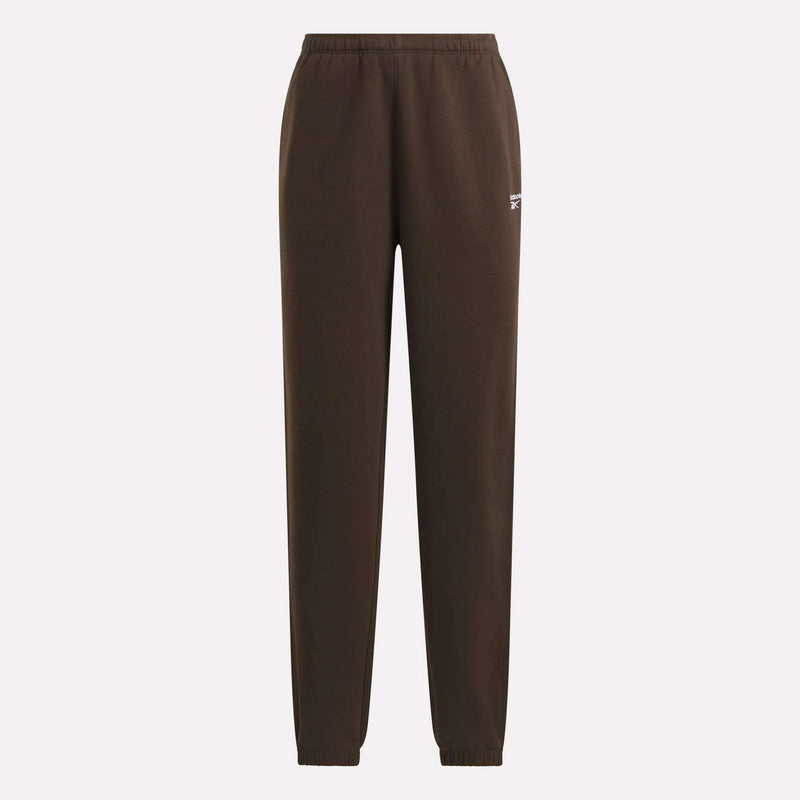 Reebok Women’s Cinch Sweatpants in brown, designed with an elastic waistband and cuffs, feature a small white Reebok logo on the upper left thigh and a modern silhouette, shown against a plain white background.