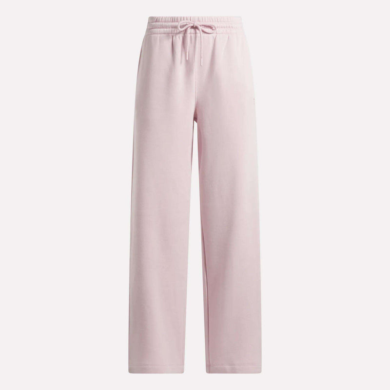 The Reebok Women’s Wide-Leg Sweatpants feature an elastic waistband with a drawstring tie, straight wide legs, and come in a light pink color. Designed for softness and comfort, these sweatpants are ideal for loungewear or casual outings.