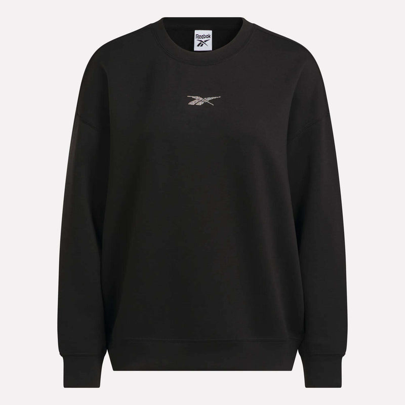 The Women’s Relaxed Crewneck Sweatshirt by Reebok is a black, roomy sweatshirt featuring a small Reebok logo at the center of the chest. Designed for comfort, it has long sleeves and ribbed cuffs, neckline, and hem that create a relaxed silhouette.