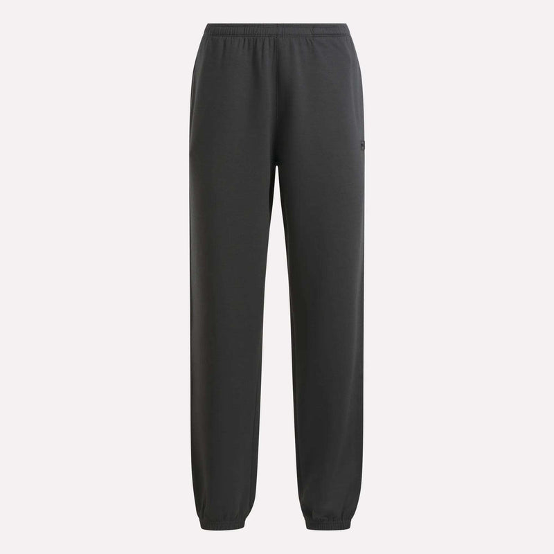 The Reebok Women’s Cinched Joggers feature an elastic waistband and elastic ankle cuffs for a secure fit, combining soft comfort and modern style in a dark gray design, shown here against a plain light background.