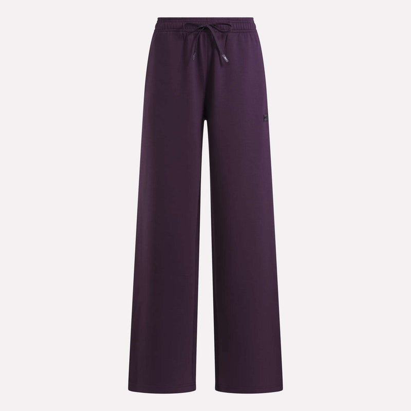 Reebok Women’s Mid-Rise Wide-Leg Pants in dark purple, showcasing a relaxed fit with an elastic drawstring waistband, displayed against a plain white background.