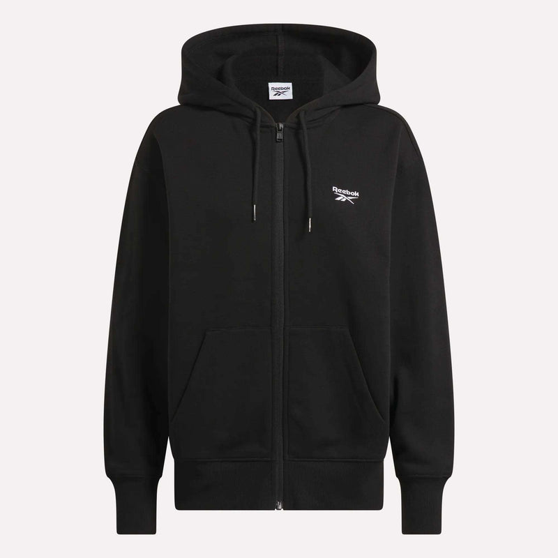 Reebok Women’s Oversized Full-Zip Hoodie for Black women, featuring a front zipper, two pockets, drawstring hood, and small white Reebok logo on the chest. Shown on a plain light background.