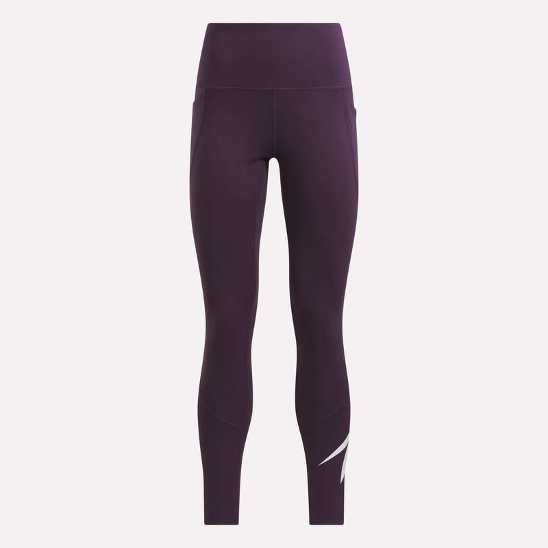 Displayed against a plain light background, the Reebok Women’s Logo High-Rise Leggings feature a deep purple hue, a slim fit, and a white abstract lightning design near the left ankle. These high-rise leggings effortlessly blend style and comfort for any active routine.