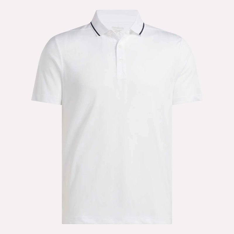 A Men’s Tournament Polo Shirt by Reebok, featuring a plain white design with short sleeves, a collared neckline with three buttons, and a thin dark stripe accenting the collar edge, is displayed on a white background.
