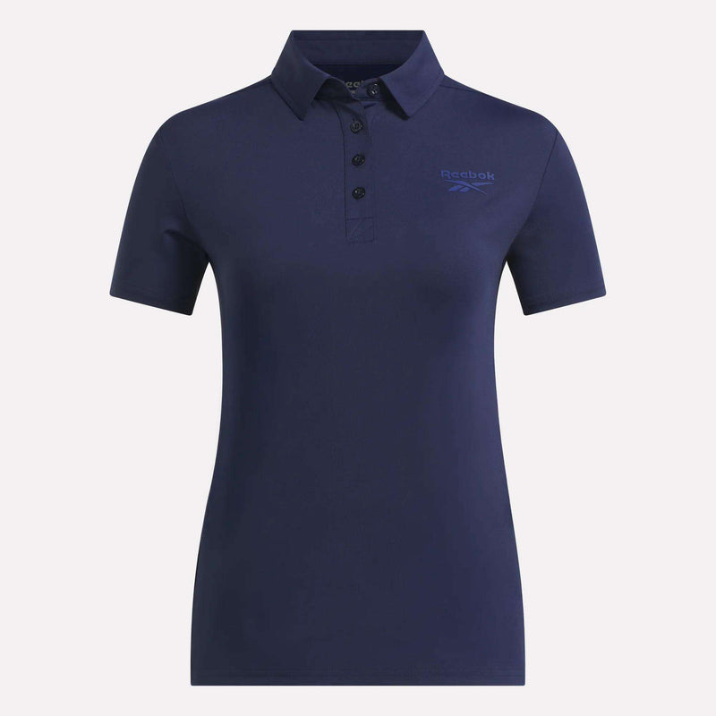 The Reebok Women's Solid Core Polo Shirt in navy blue features a collared design with three buttons and a subtle Reebok logo on the left chest. Crafted from comfortable performance jersey fabric, this fitted polo offers short sleeves—making it an excellent choice for both casual outings and golf days on the green.