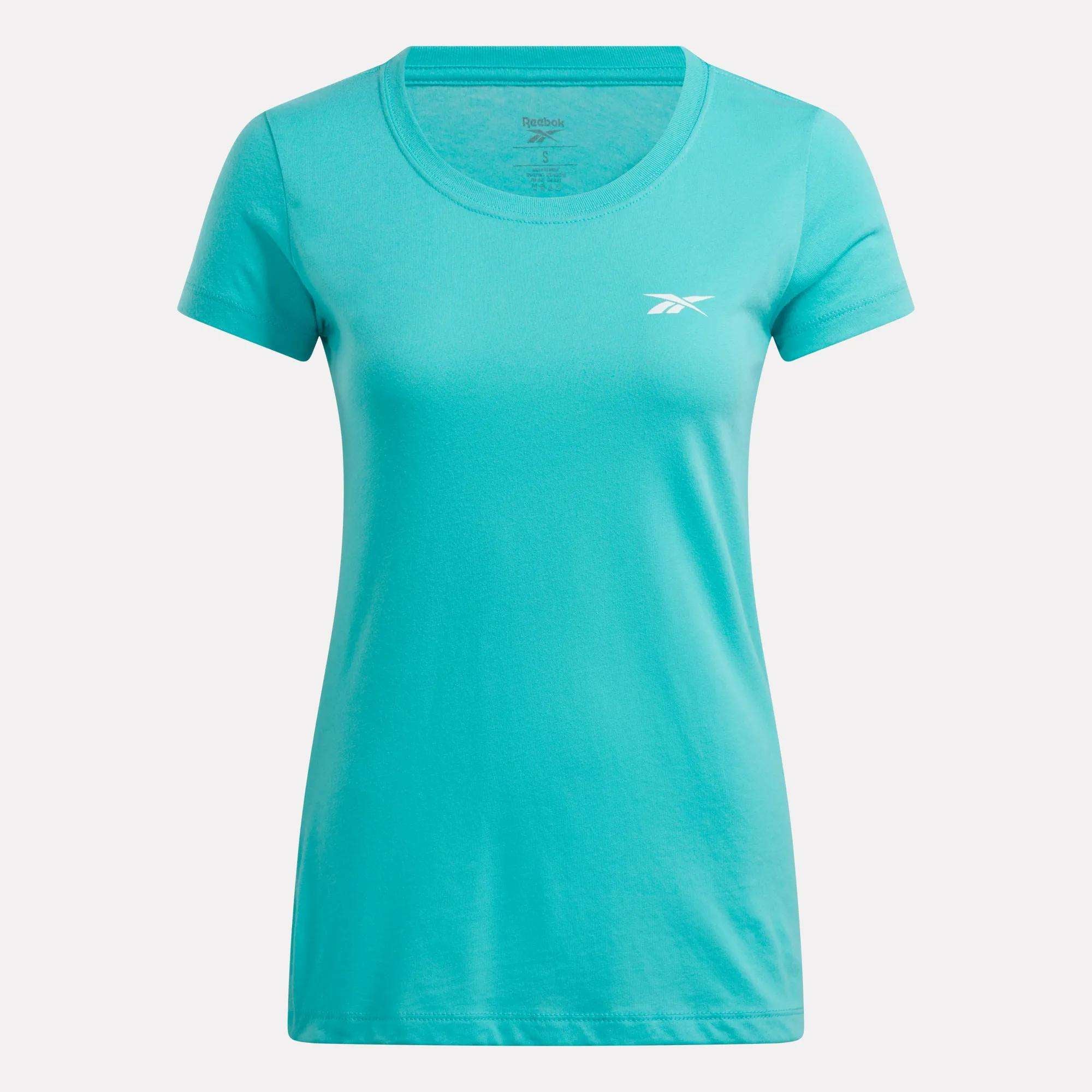 A teal Reebok women's cotton t-shirt with short sleeves, a round neckline, and a small white logo on the left chest is shown against a plain white background.