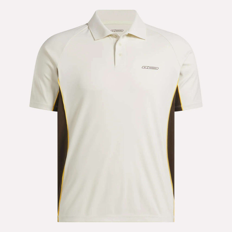 The Reebok x Manors Men’s Polo is a white short-sleeve golf shirt featuring brown side panels, yellow trim, and a small logo on the left chest. Part of the stylish Reebok collection, this men’s golf polo is crafted for comfort and performance on the course.