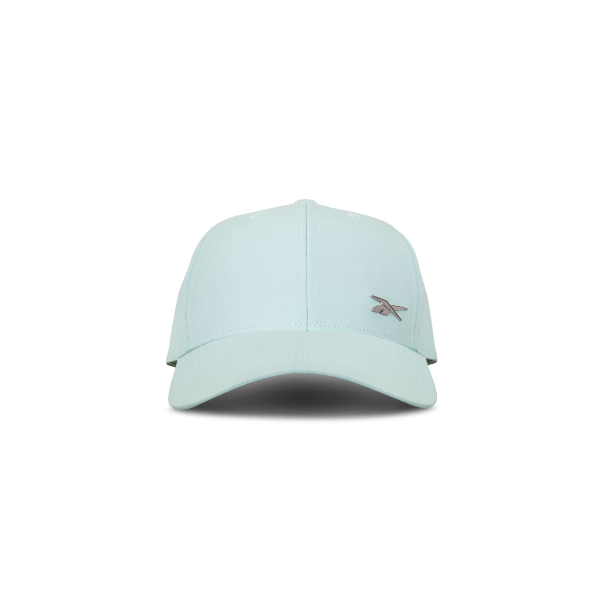 The Reebok Badge Cap in light blue features a curved brim, small embroidered front-left logo, and a Speedwick sweatband for moisture-wicking comfort. Shown facing forward on a white background.