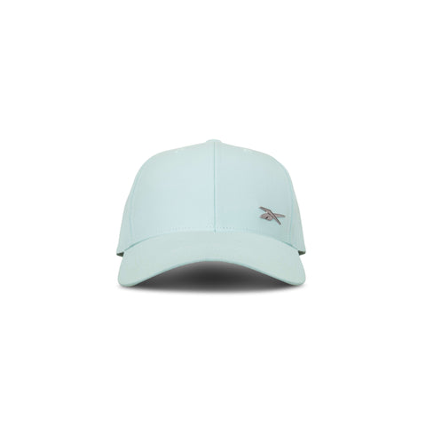 The Reebok Badge Cap in light blue features a curved brim, small embroidered front-left logo, and a Speedwick sweatband for moisture-wicking comfort. Shown facing forward on a white background.