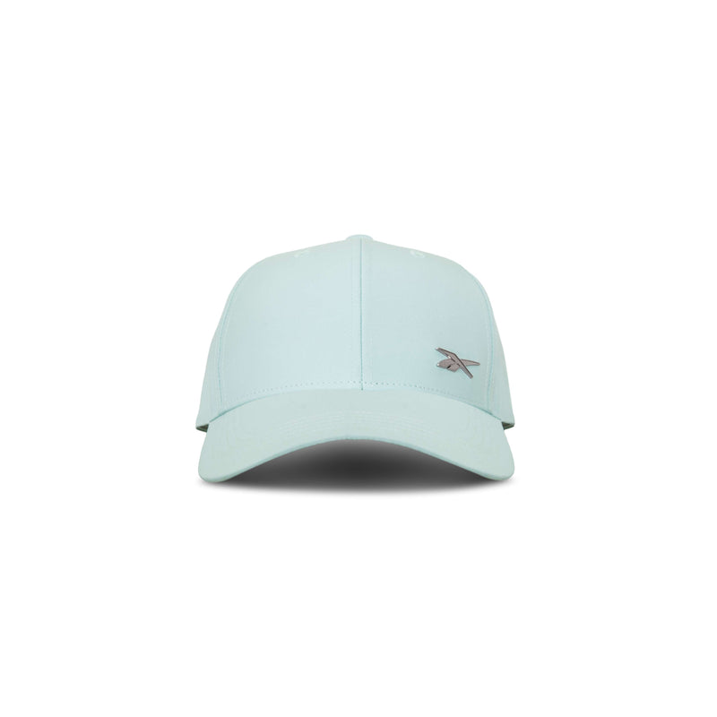 The Reebok Badge Cap in light blue features a curved brim, small embroidered front-left logo, and a Speedwick sweatband for moisture-wicking comfort. Shown facing forward on a white background.