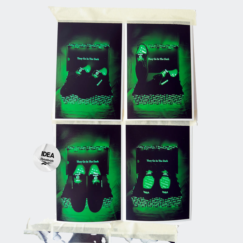 Four dark photos highlight the glow-in-the-dark Reebok x IDEA Club C 85 Shoes from the exclusive collaboration between Reebok and IDEA bookstore, featuring green neon accents and a “They Go In The Dark” label. An IDEA x Reebok logo tag is visible, with the images arranged in a 2x2 grid on fabric.