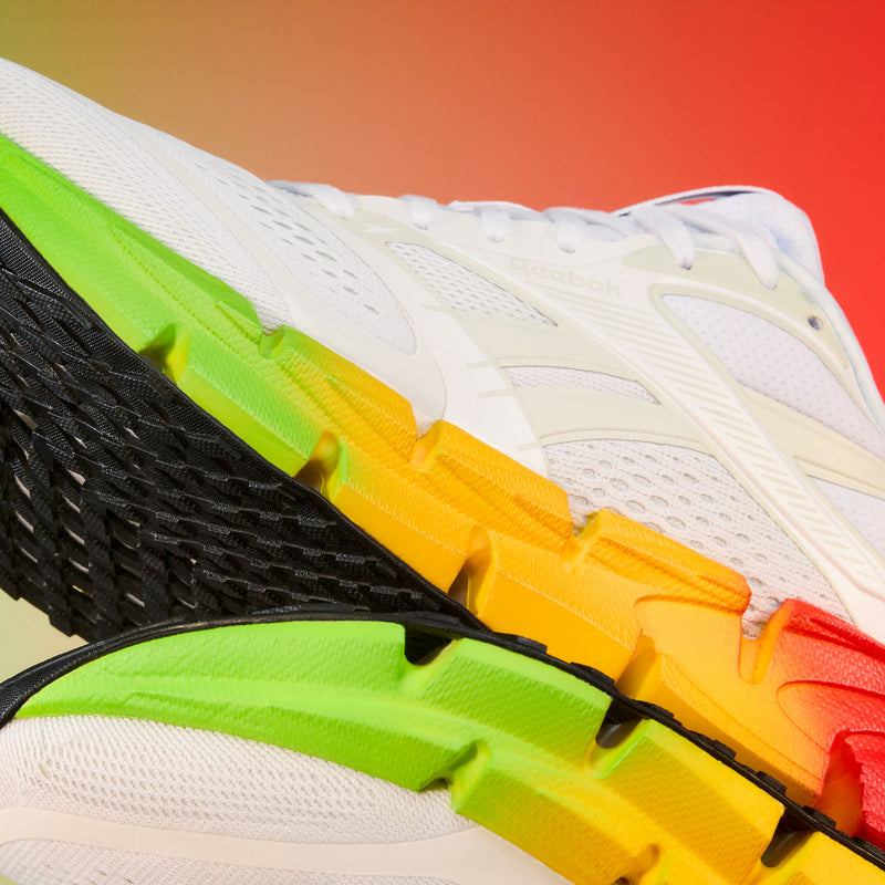 Close-up of a sneaker with multicolored sole on a gradient background