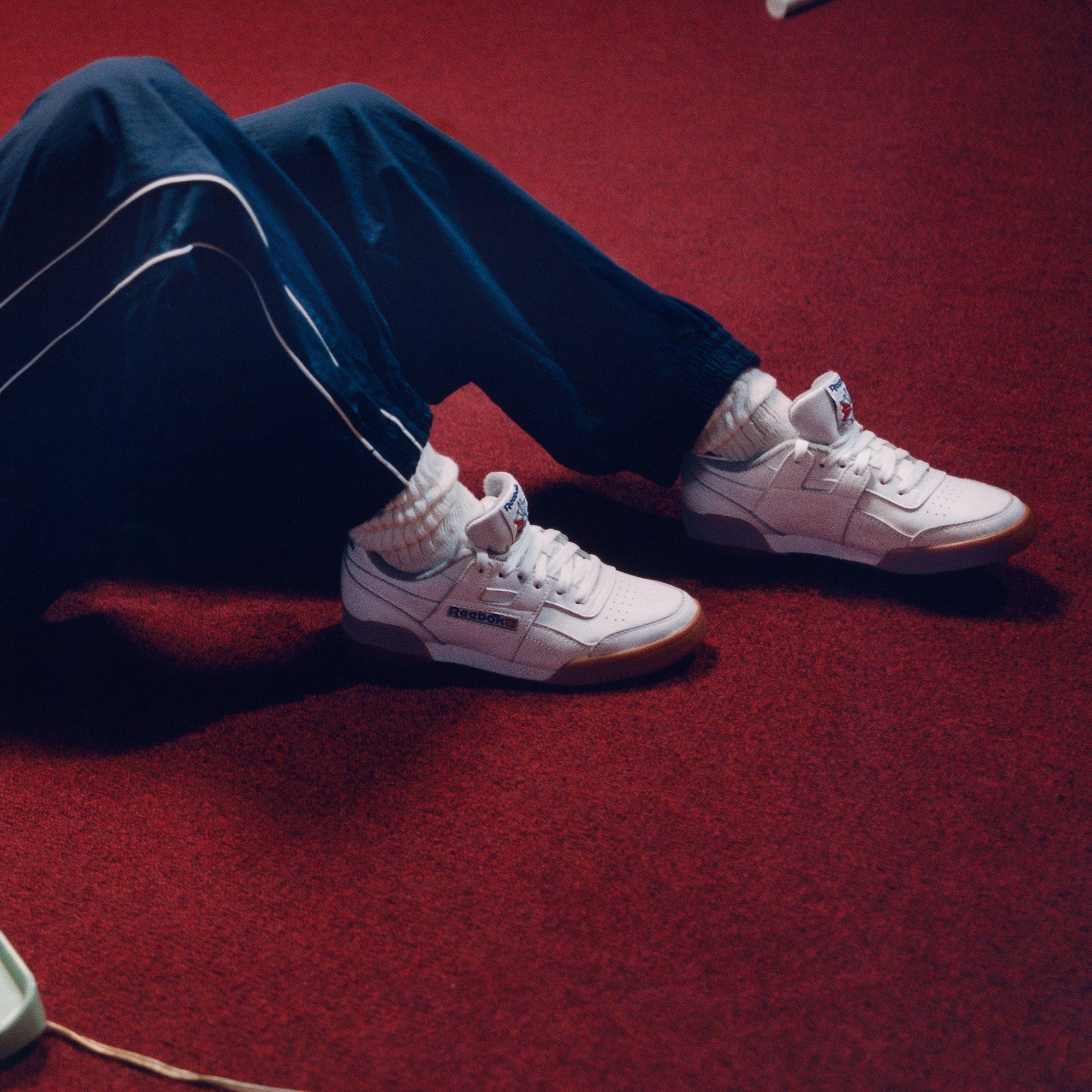 A person wearing white shoes.