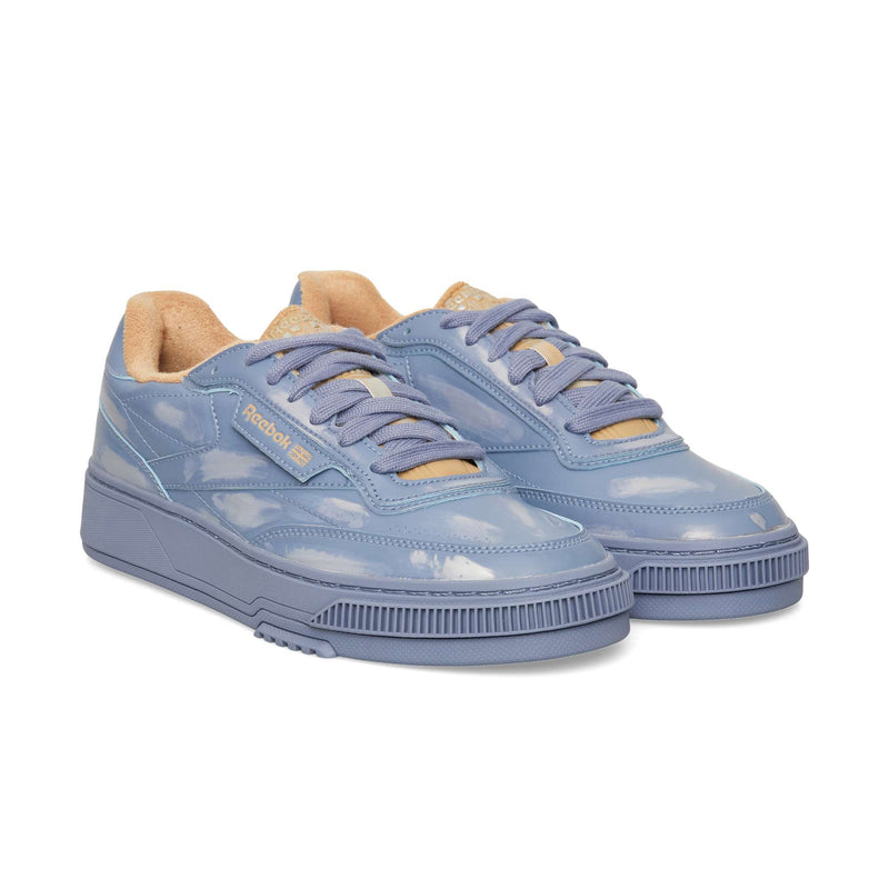 Reebok Club C LTD periwinkle blue tennis shoe with a cloud pattern, thick textured soles, and tan inner lining, perfect for casualwear.