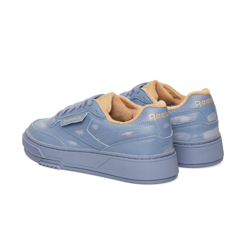 Blue Reebok Club C LTD low-top sneakers with cloud-like patterns, thick rubber soles, and tan inner lining.
