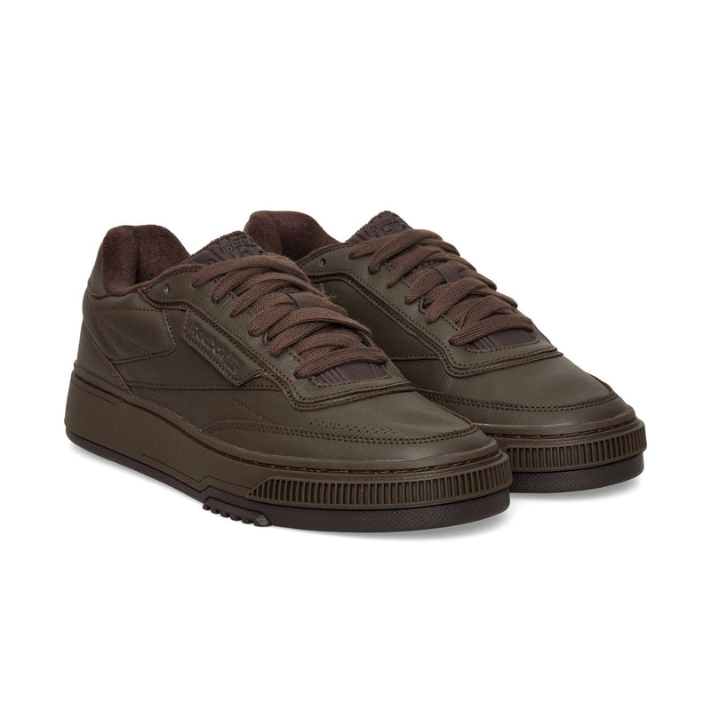 Dark brown Reebok Club C LTD low-top sneakers with matching laces and a thick, ridged rubber sole.