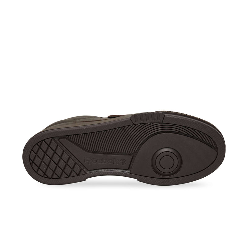 Dark brown rubber outsole of a Reebok Club C LTD sneaker featuring a textured grip pattern and a central circular pivot point.