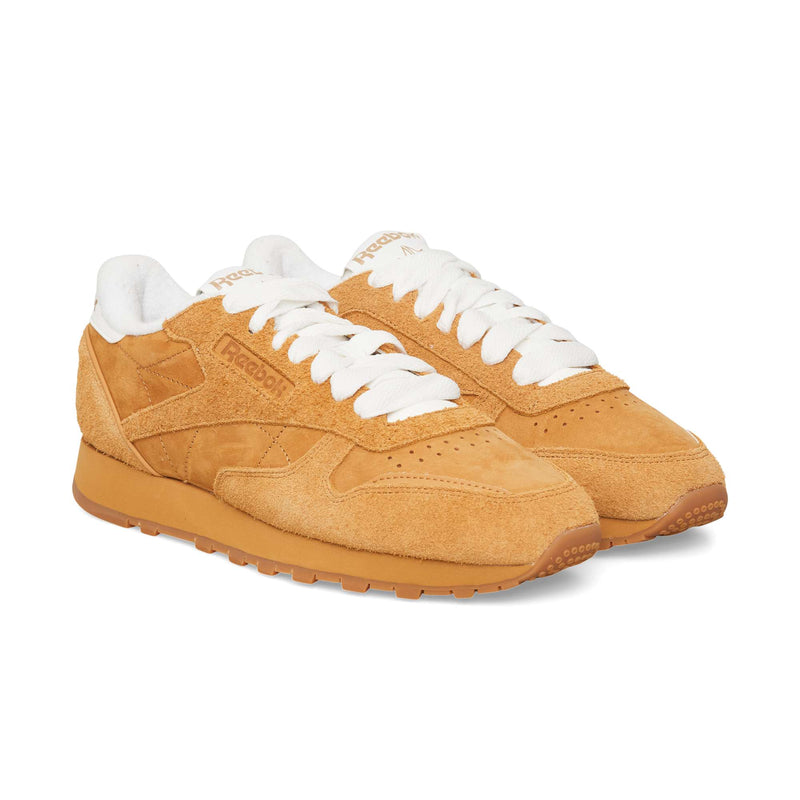 Tan suede Reebok Classic Leather Premium sneakers featuring white laces and a white inner lining.