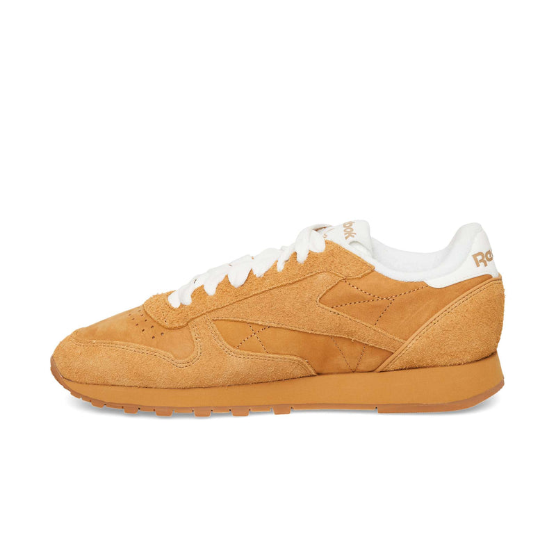 Tan suede Reebok Classic Leather Premium sneakers featuring white laces, a white interior lining, and a gum rubber sole.