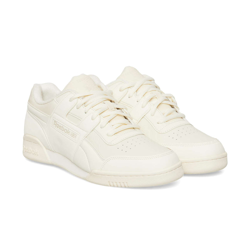 Off-white Reebok Workout Plus OG sneakers featuring a classic silhouette, low-top design with laces, and a flat rubber sole.