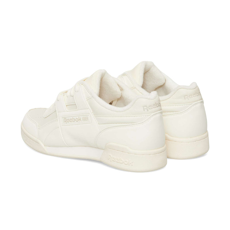 Off-white Reebok Workout Plus OG low-top sneakers shown from a rear three-quarter angle, highlighting their classic silhouette.