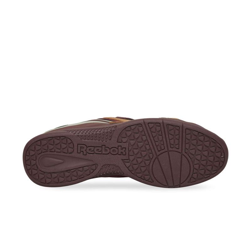 Dark brown durable rubber sole of a Reebok Hammer Pro LTD sneaker, featuring a circular pivot point and geometric tread pattern.