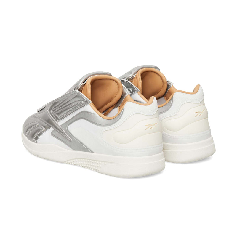 Reebok Hammer Pro LTD sneakers in white and silver with tan linings, viewed from a rear-quarter angle on a durable rubber sole.