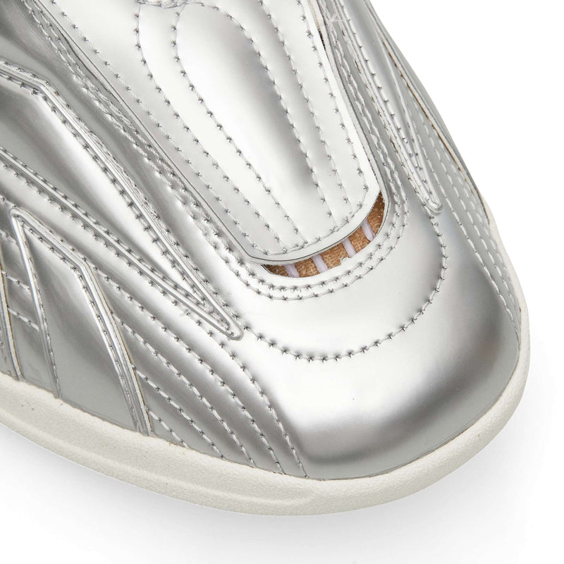 Close-up of the toe of a metallic silver Reebok Hammer Pro LTD sneaker with stitched paneling and a durable rubber sole.