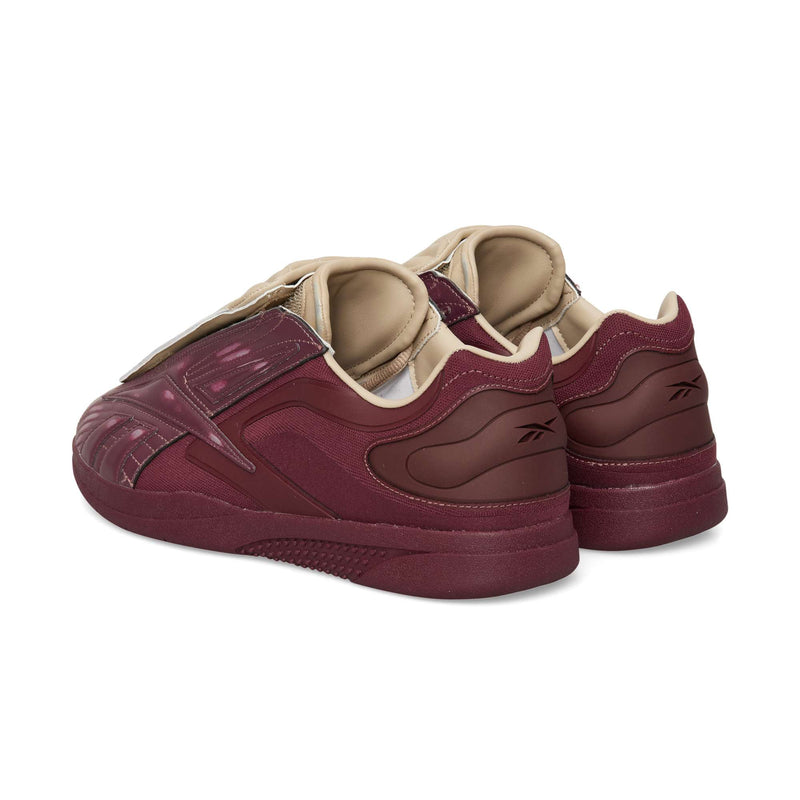Two maroon Reebok Hammer Pro LTD leather sneakers shown from a rear-three-quarter view, featuring a tan inner collar and a hook-and-loop strap across the top.