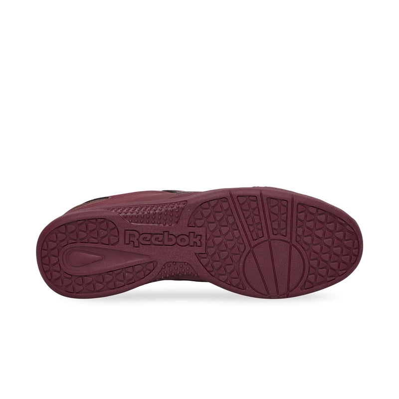 The maroon rubber outsole of a Reebok Hammer Pro LTD sneaker, featuring a textured tread pattern and a brand logo in the center.