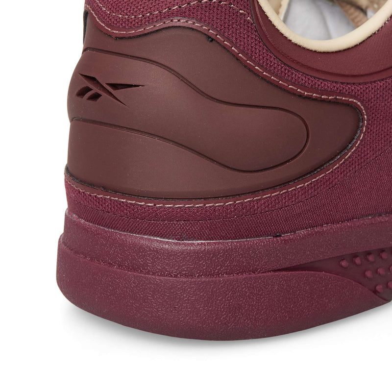 Close-up of the burgundy heel of a Reebok Hammer Pro LTD sneaker with a molded logo detail.