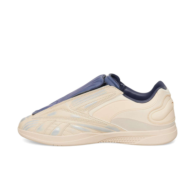 Reebok Hammer Pro LTD low-top sneaker in cream with a dark blue tongue cover and a durable rubber sole.
