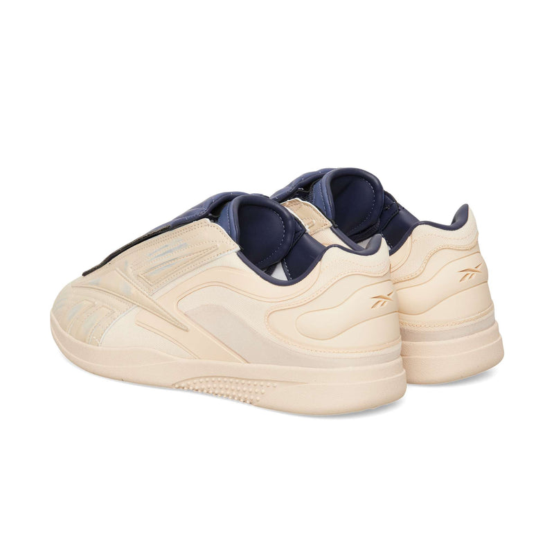 Beige Reebok Hammer Pro LTD sneakers featuring a leather upper with a dark blue tongue and interior lining.