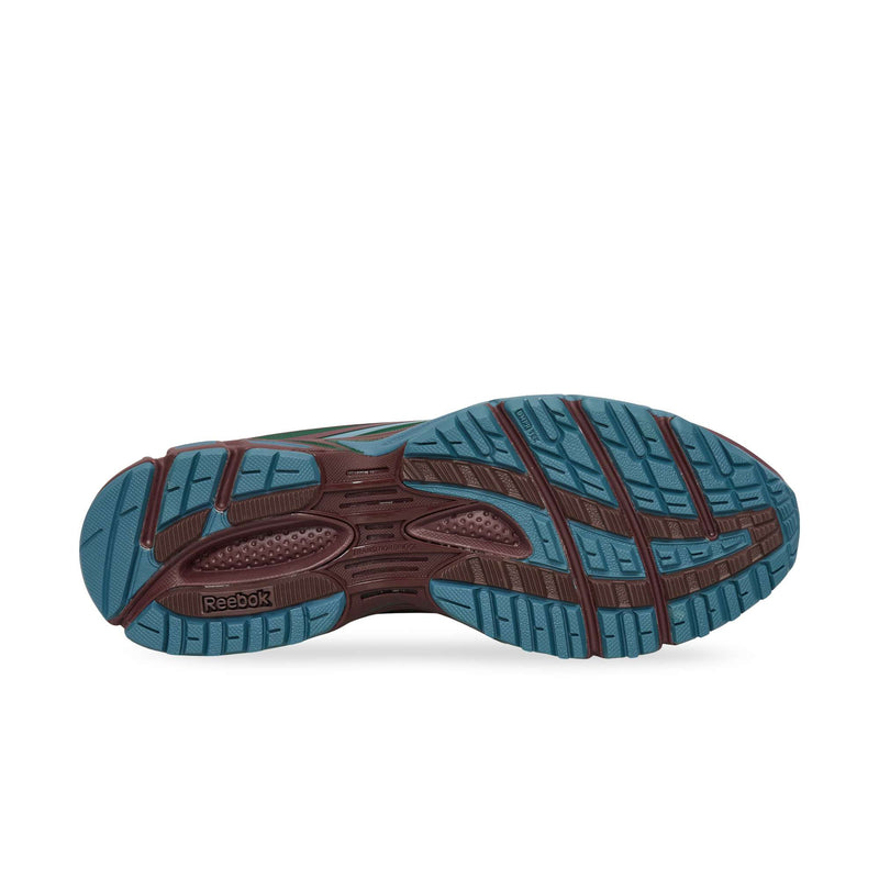 Blue and burgundy lugged rubber outsole on a Reebok Premier Road Modern.